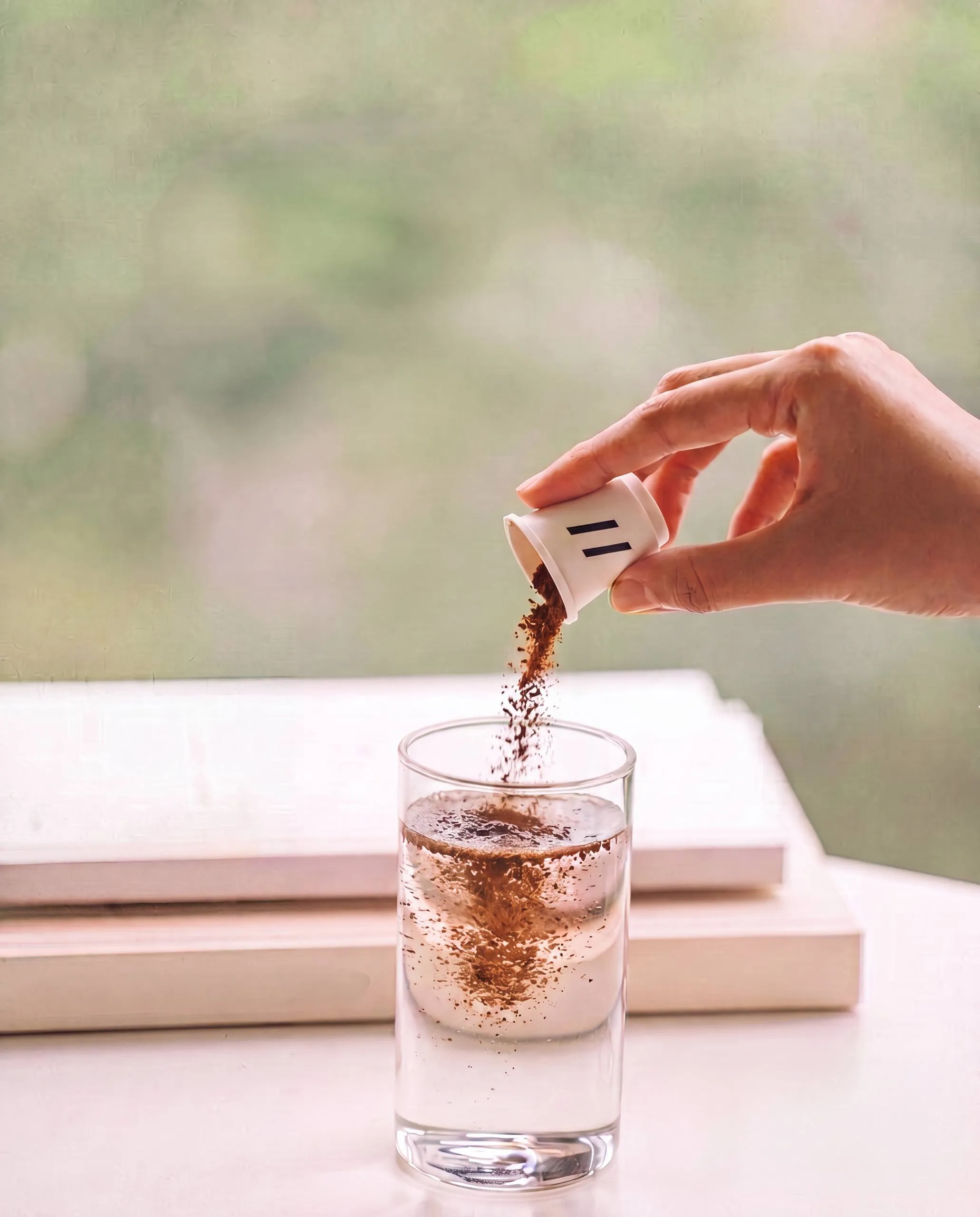 Instant coffee being poured from a Parallel cup into a glass